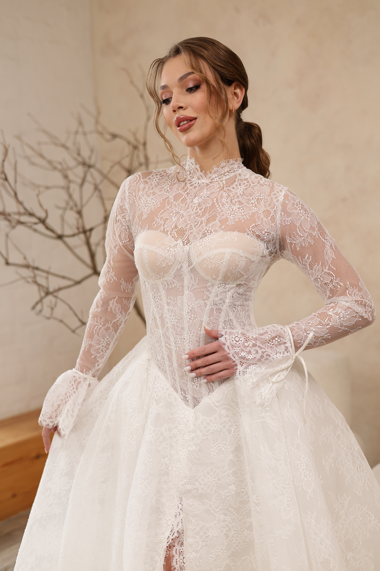 Mira — close-up of lace corset bodice and bell sleeves