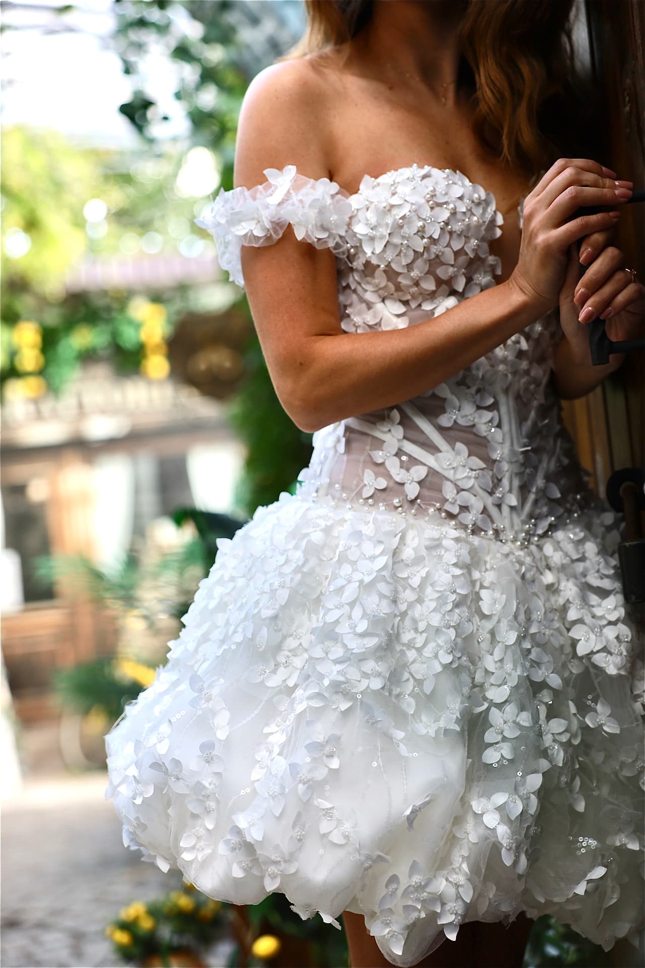 AFTER — off-the-shoulder floral sleeves framing the décolletage, cascading floral skirt