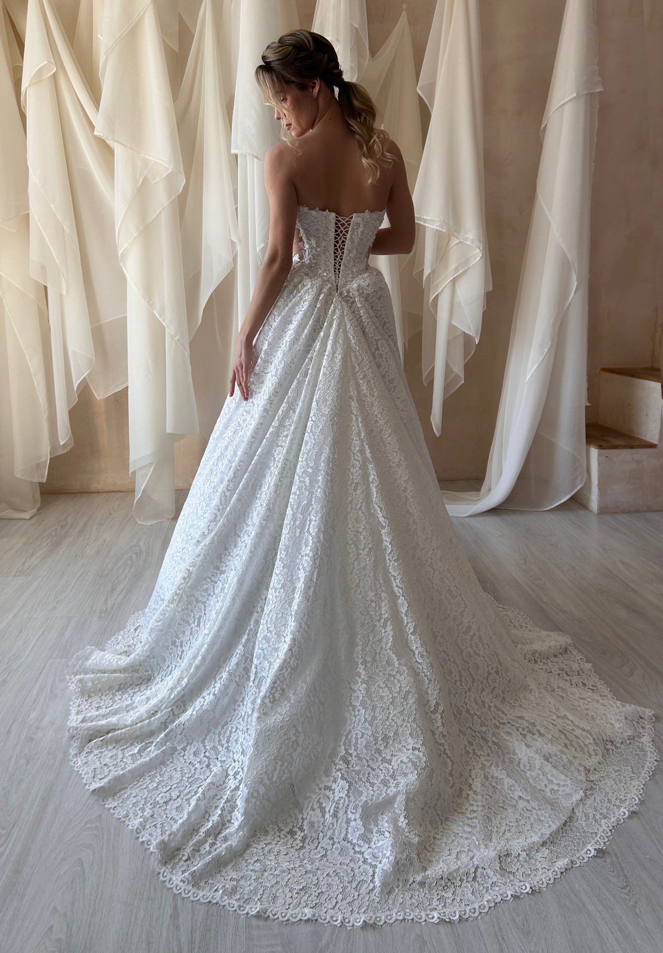 Katarina — back view of the textured lace gown with dramatic full skirt and train