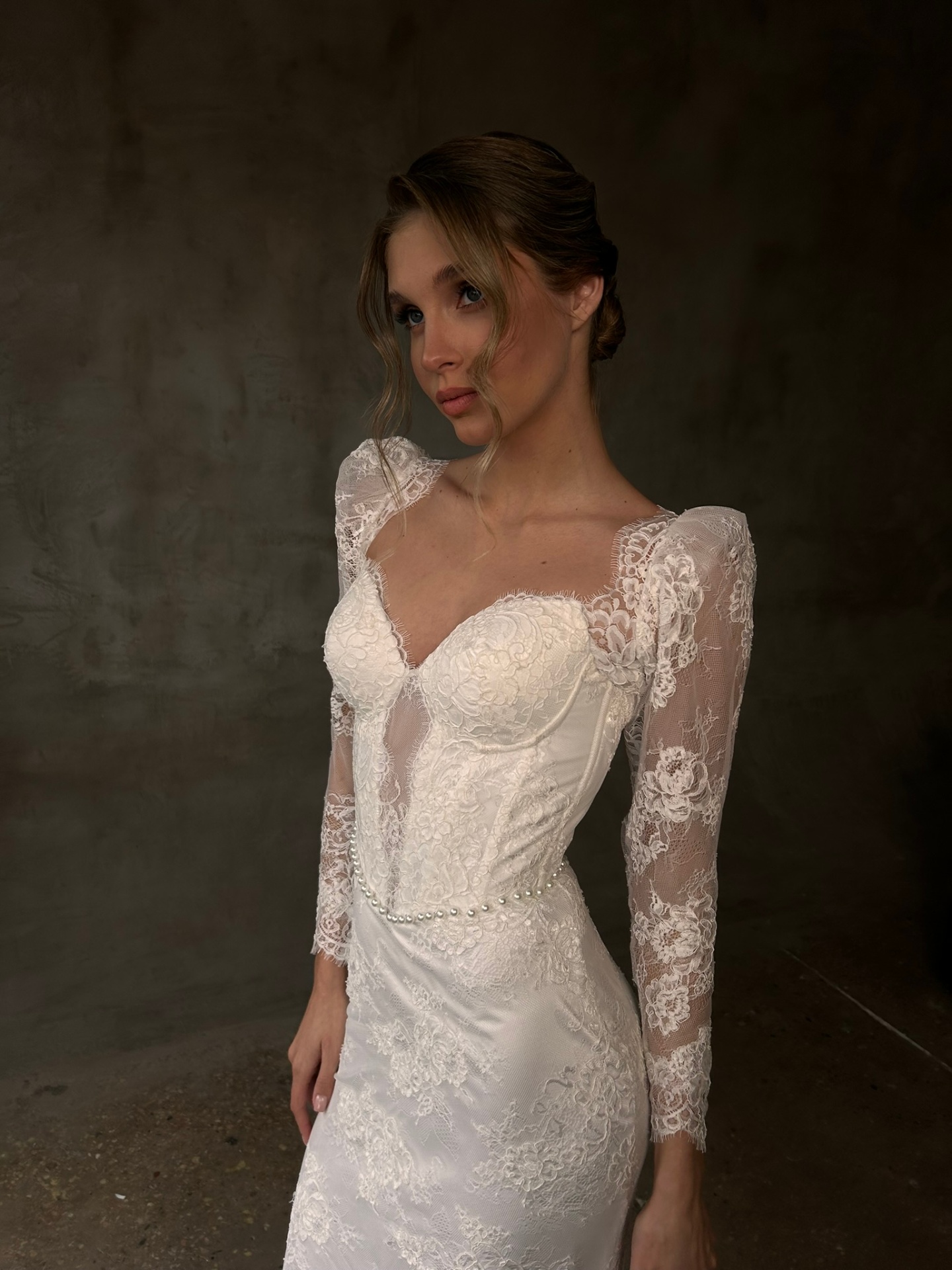 Nicole — close-up of sweetheart corset bodice with accented shoulders, sheer floral lace sleeves and pearl waist detail