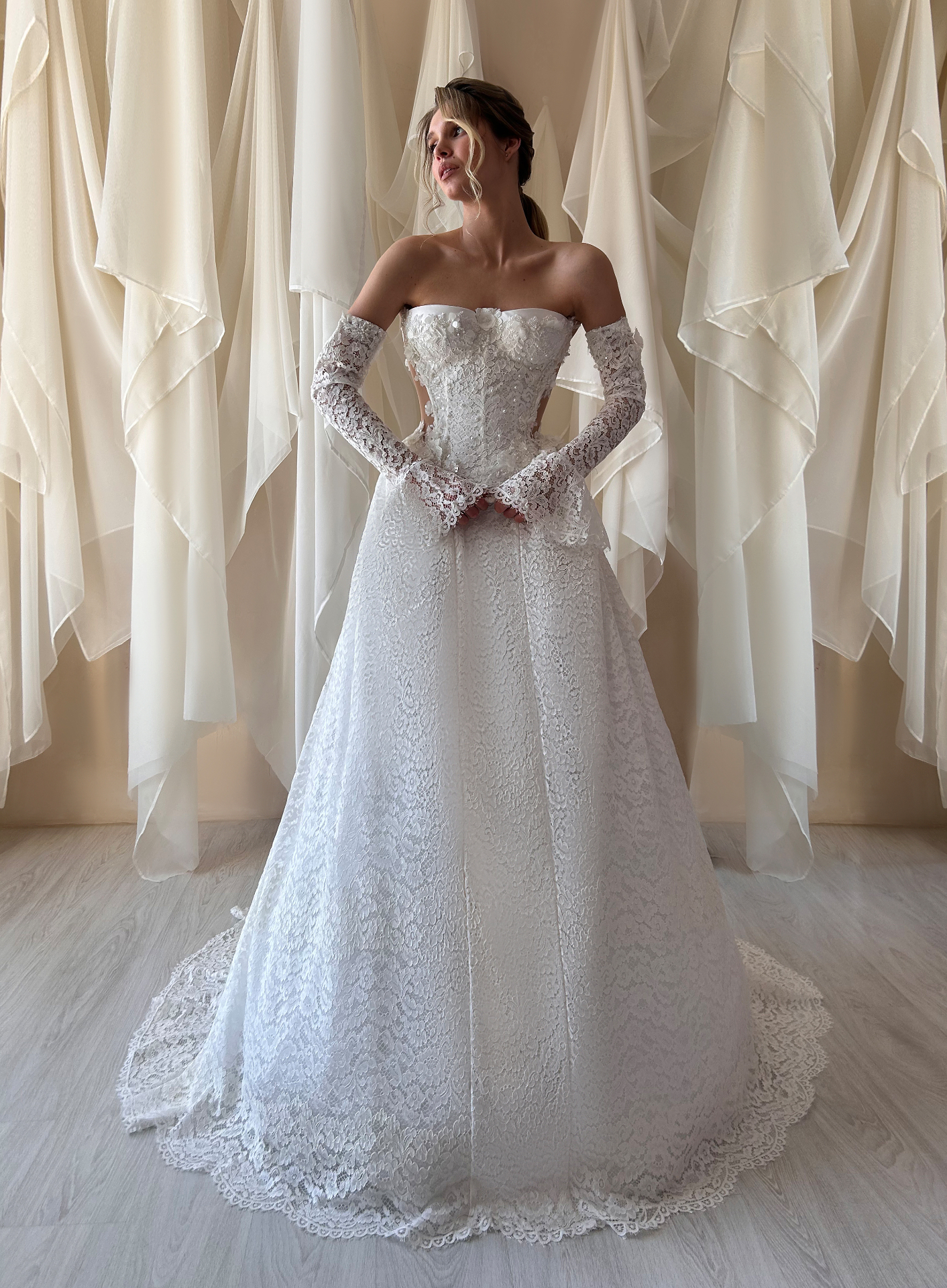 Katarina — full front view of majestic lace ballgown with strapless bodice and refined lace gloves