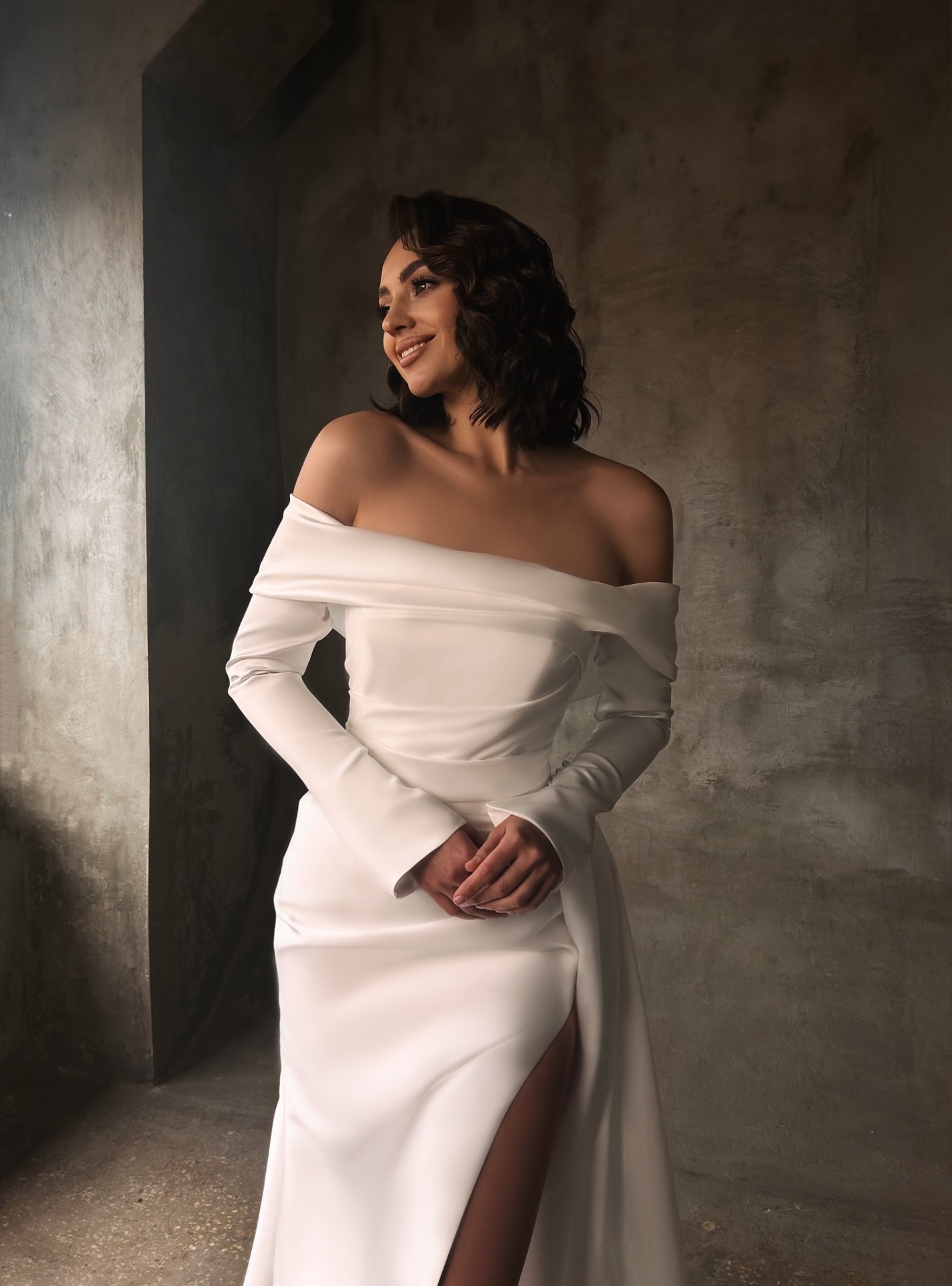 Jennifer — close-up of off-the-shoulder bodice with long tailored sleeves and draped waist