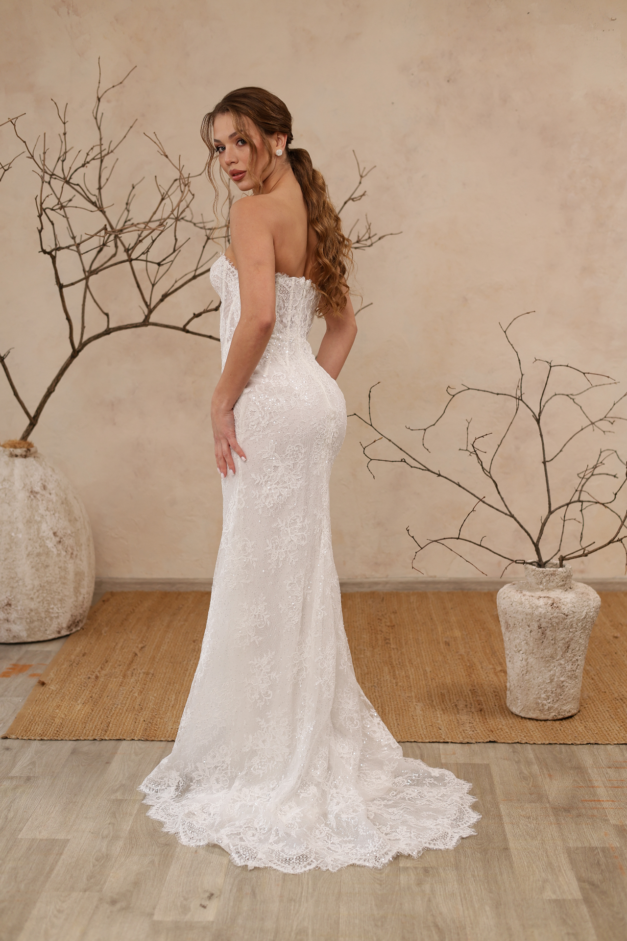 Zara — back view of slim floor-length lace silhouette with train