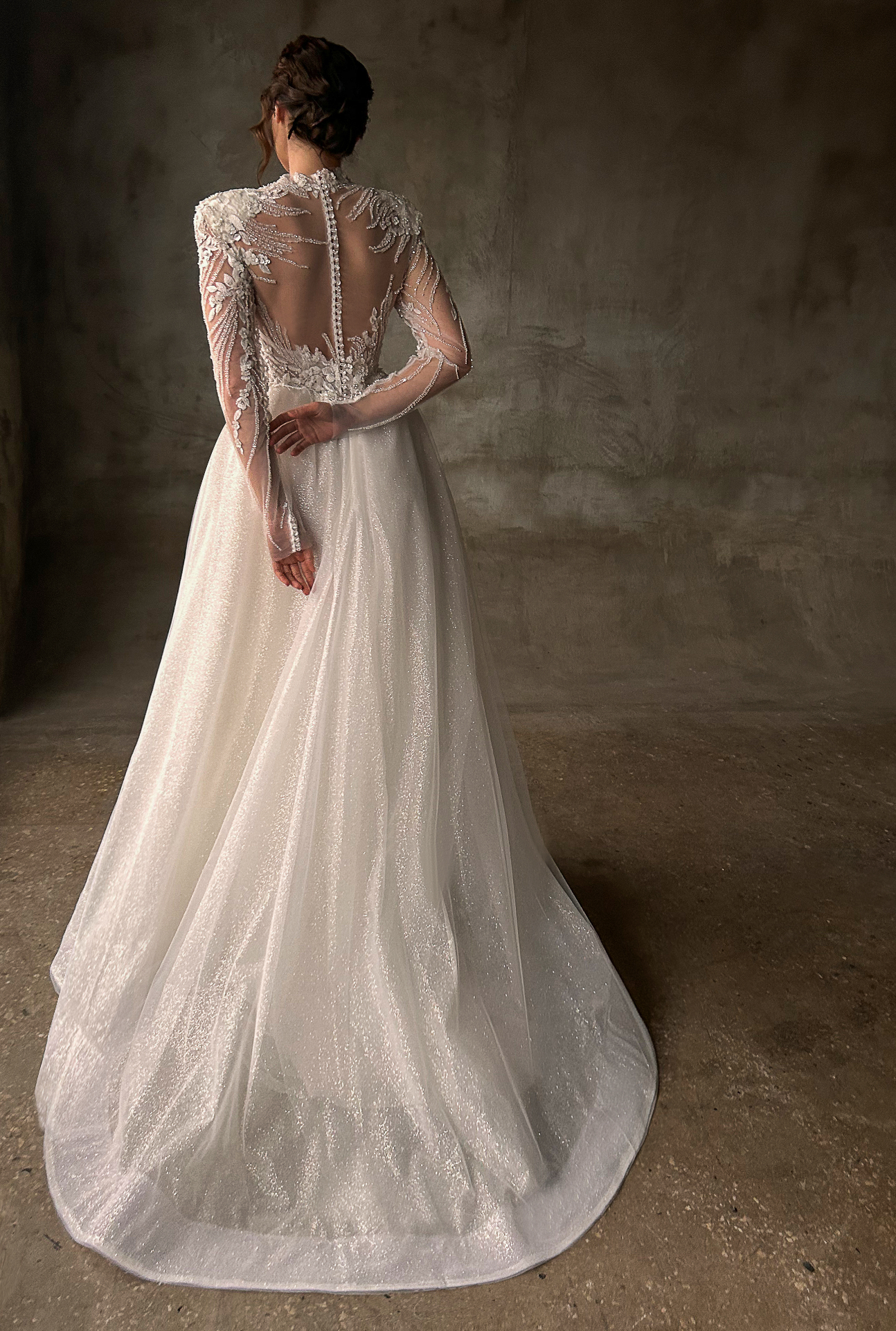 Ornella — back view of the gown with sheer illusion back, button detailing and sweeping detachable overskirt