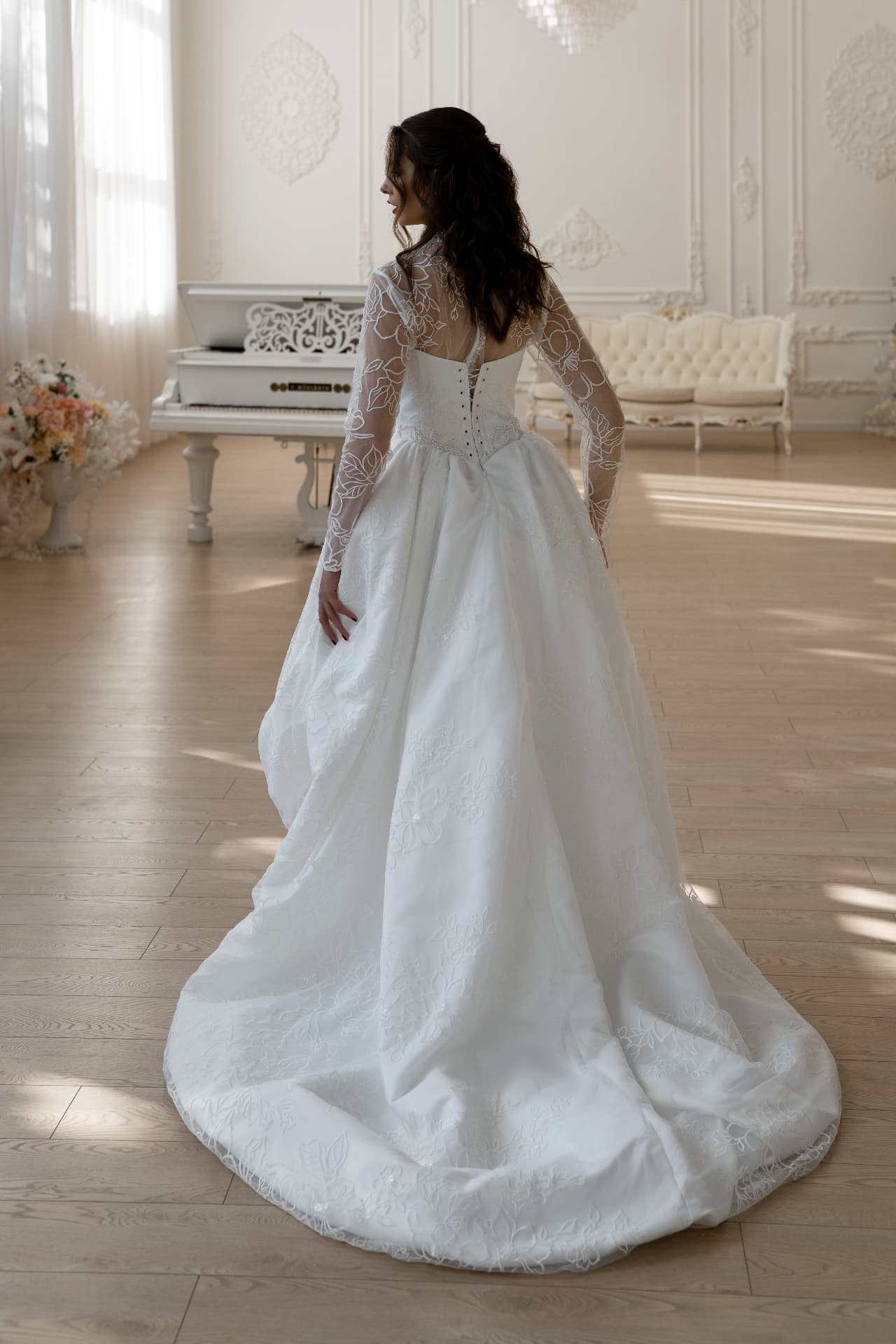 Eos — back view with long transparent sleeves and elongated train