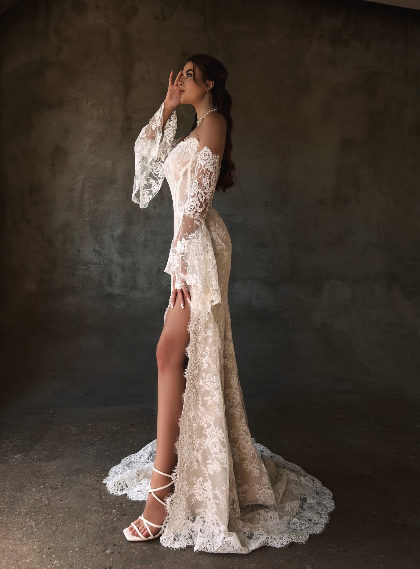 Patricia — LEMAKS Famous strapless all-over lace gown with flared sleeves and high slit