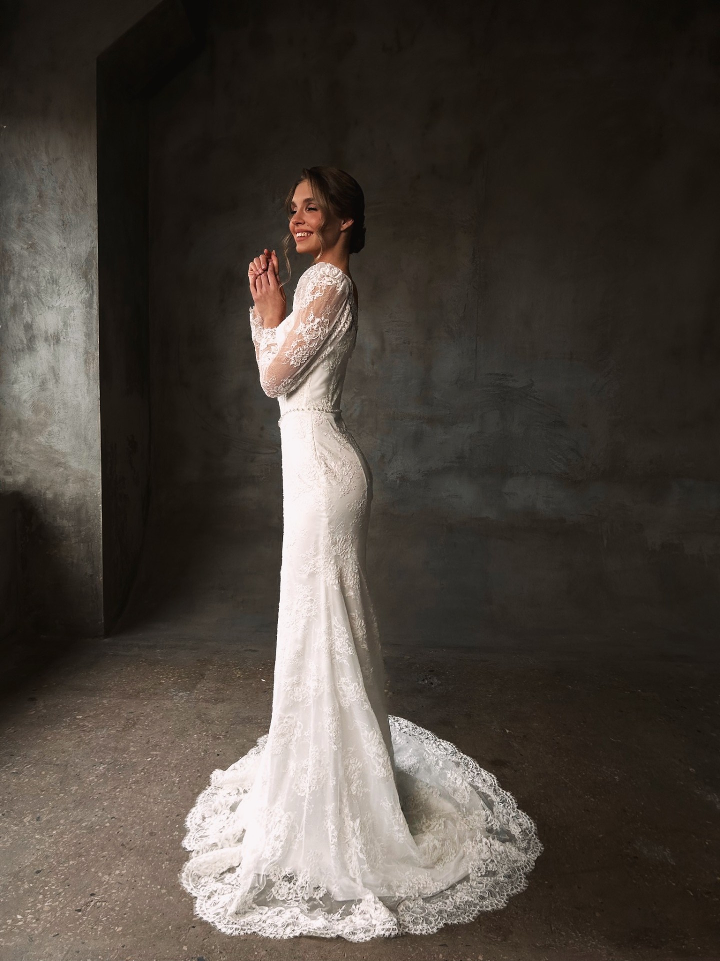 Nicole — side view showcasing the form-fitting silhouette and romantic lace train