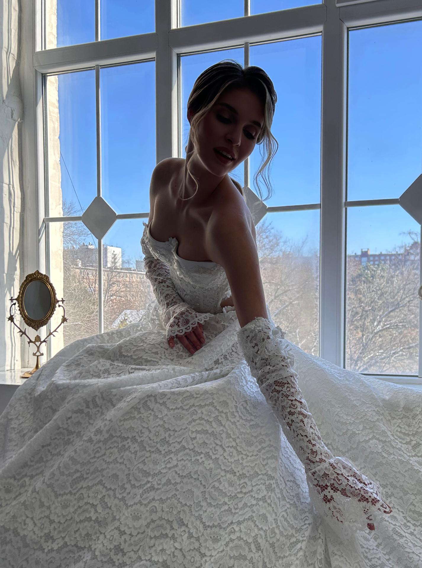 Katarina — seated portrait showing the voluminous floral lace skirt and matching lace gloves