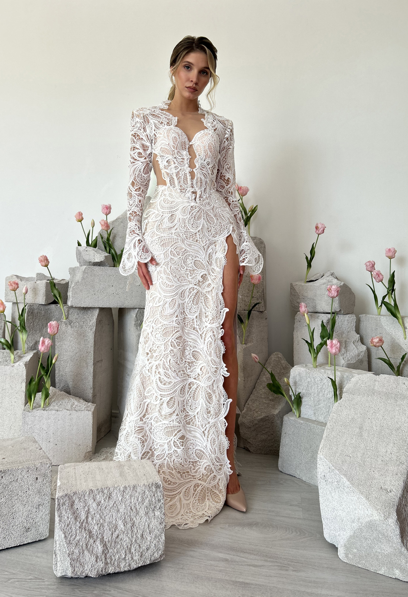 Keira — structured bodice with intricate lace, long sleeves and daring leg slit