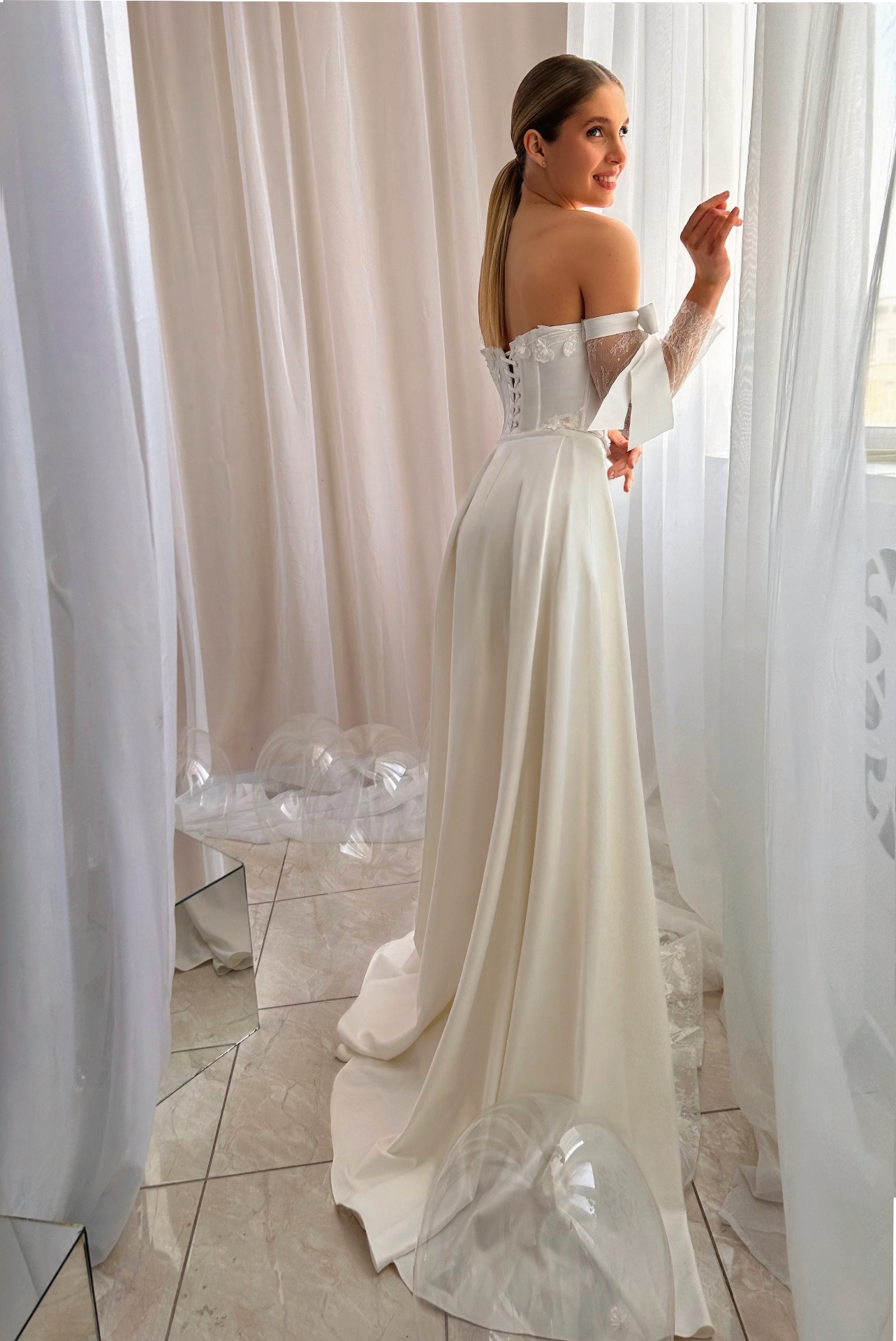 Delilah — back view showing corset lace-up and dramatic satin overskirt