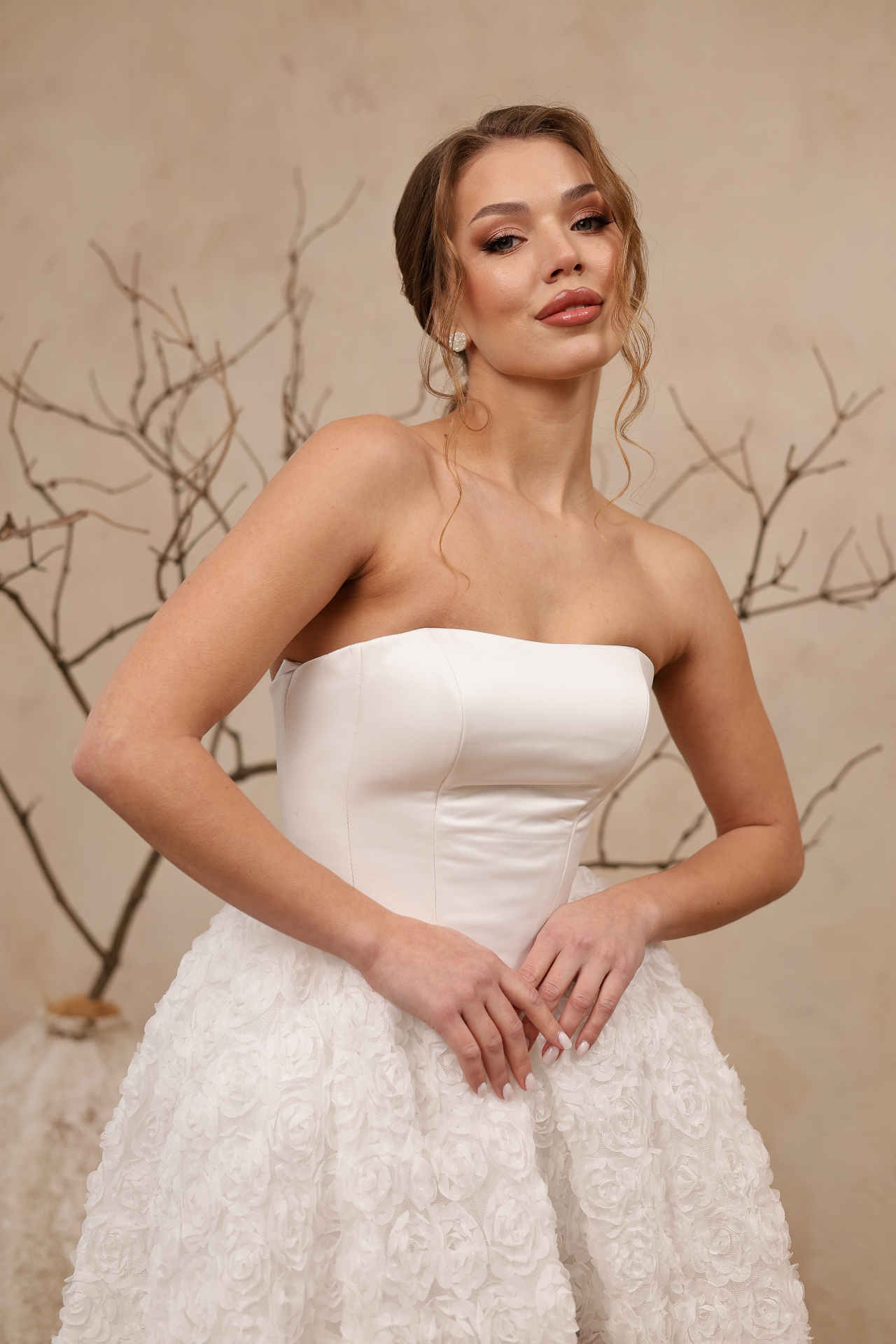 Tutti — close-up of minimalist satin bodice and sculptural 3D floral rosettes