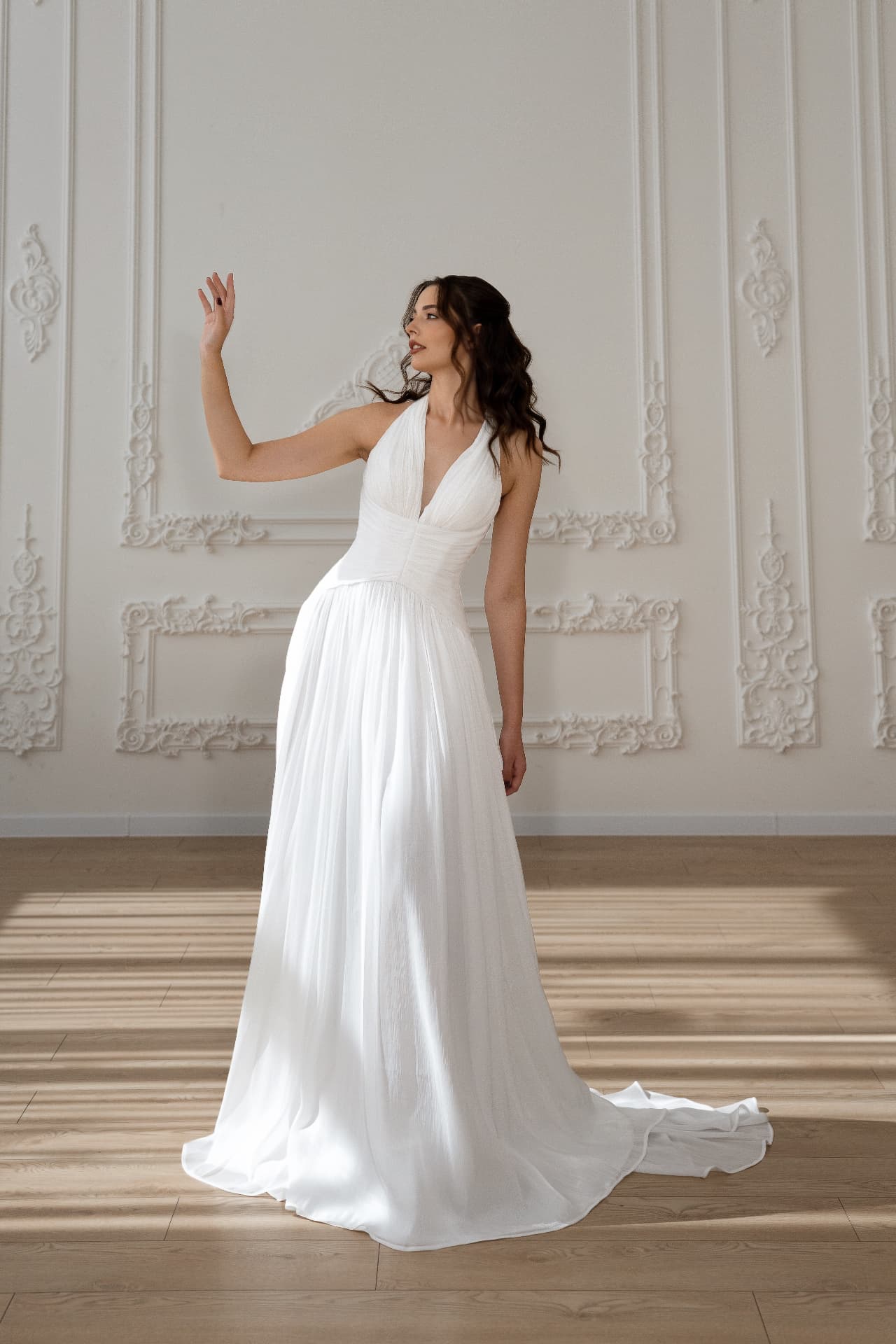 Harmonia — three-quarter view with flowing pleated skirt