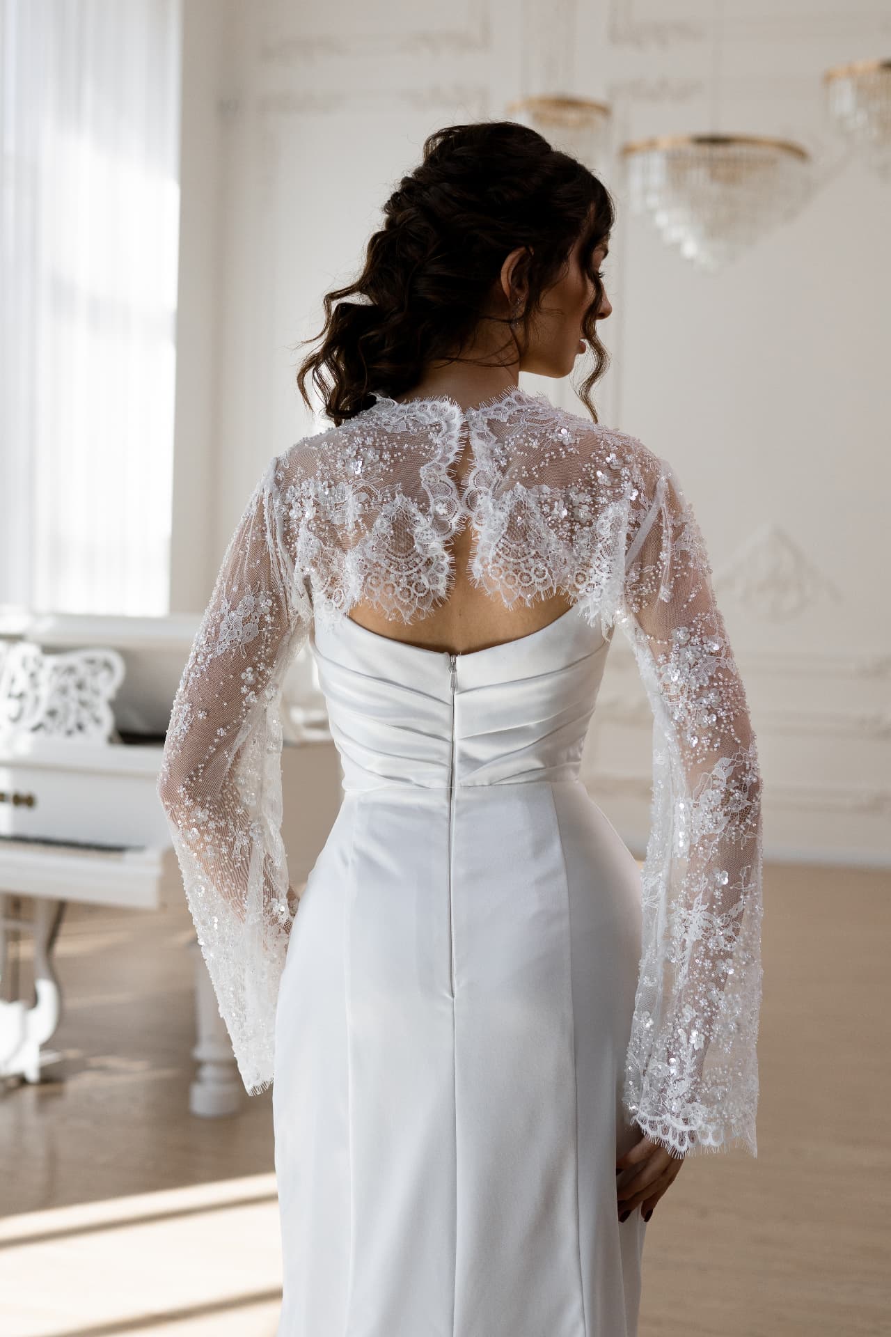 Asteria — back detail with sheer lace overlay and long flared sleeves