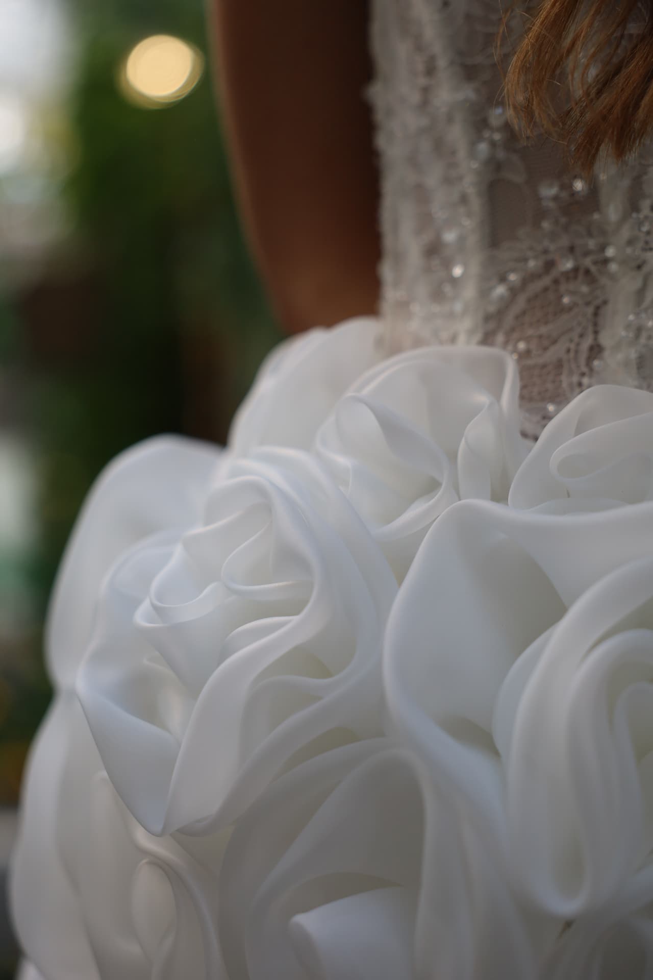 ÉCLAT — close-up of the oversized petal-like folds creating the striking floral effect