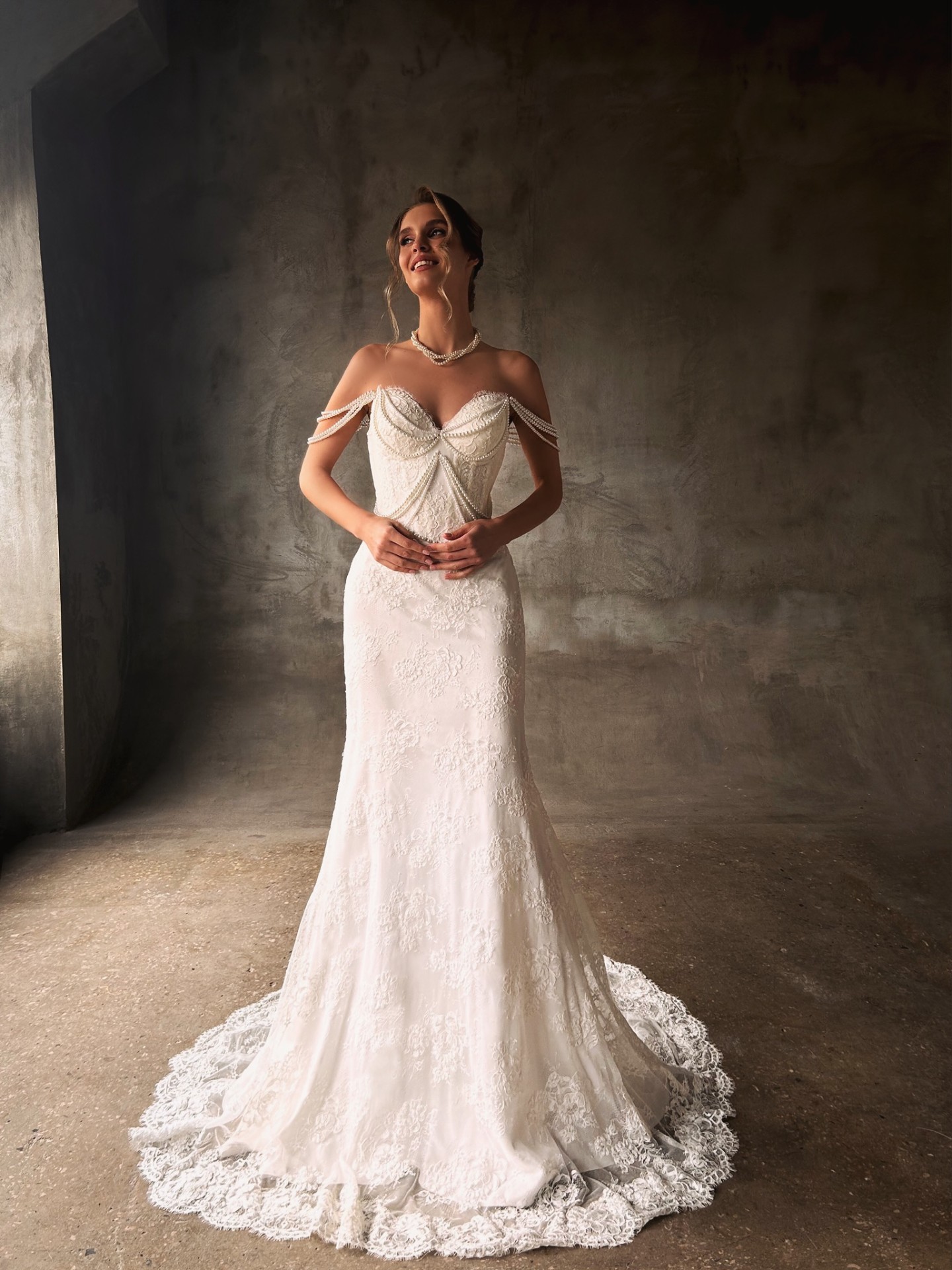 Elizabeth — full front view with off-shoulder pearl strands and intricate lace skirt