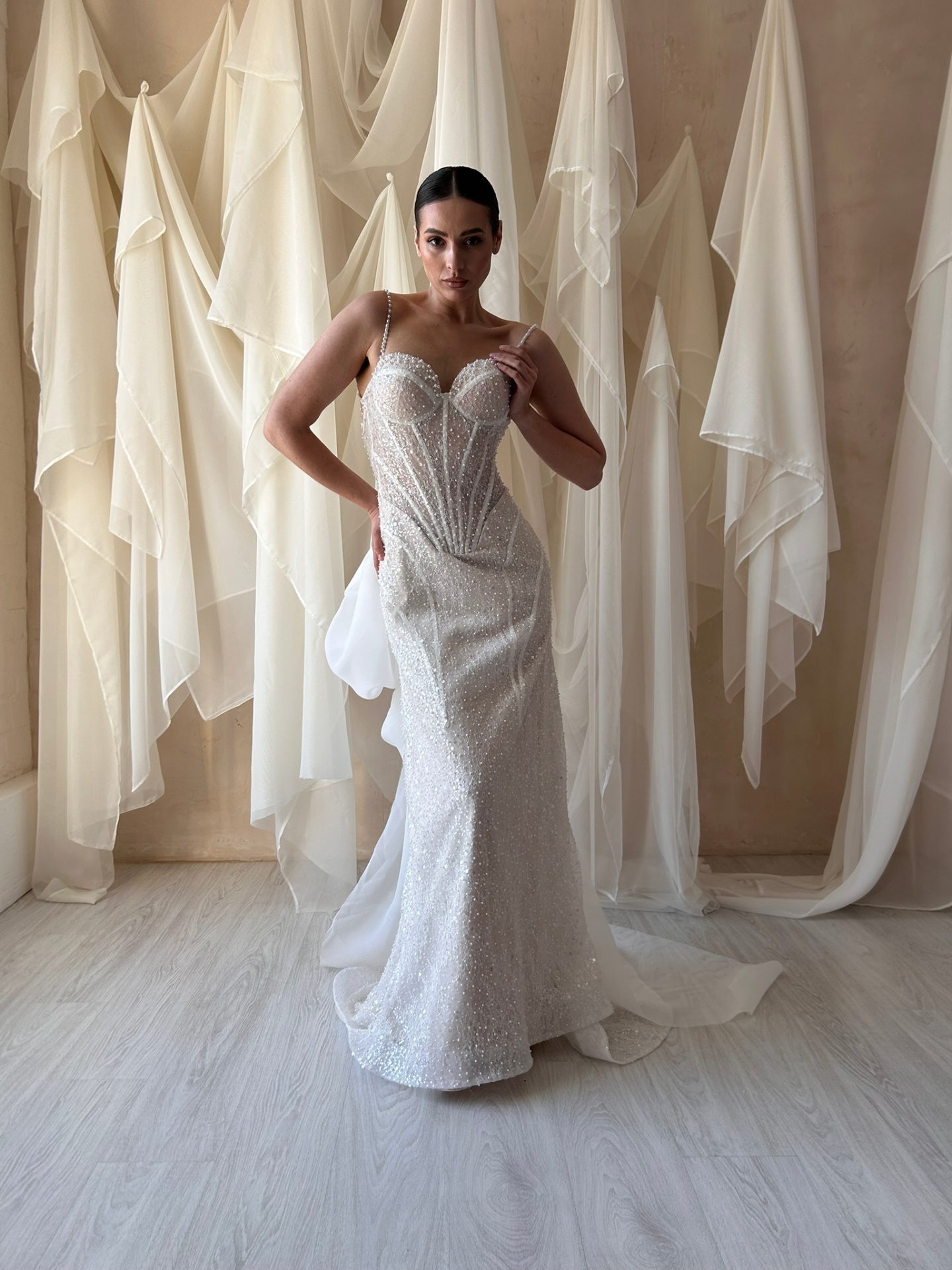 Michele — full-length silhouette showcasing the body-hugging beaded fit and trailing organza bow