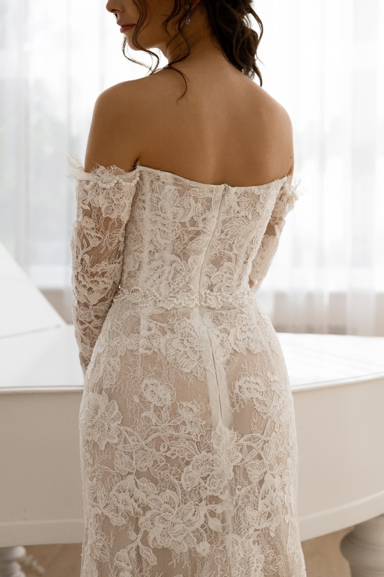 IRIS — open back detail with sheer lace sleeves and pearl waist trim