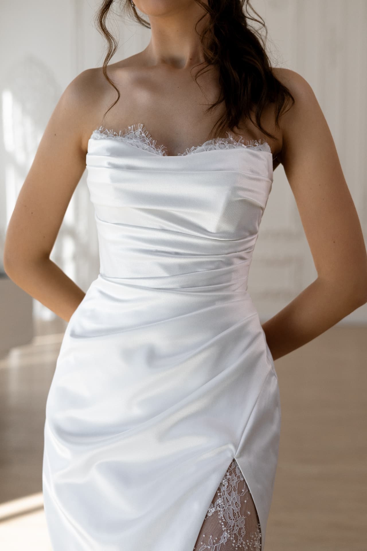 Asteria — close-up of the draped satin bodice and slit lined with beaded lace