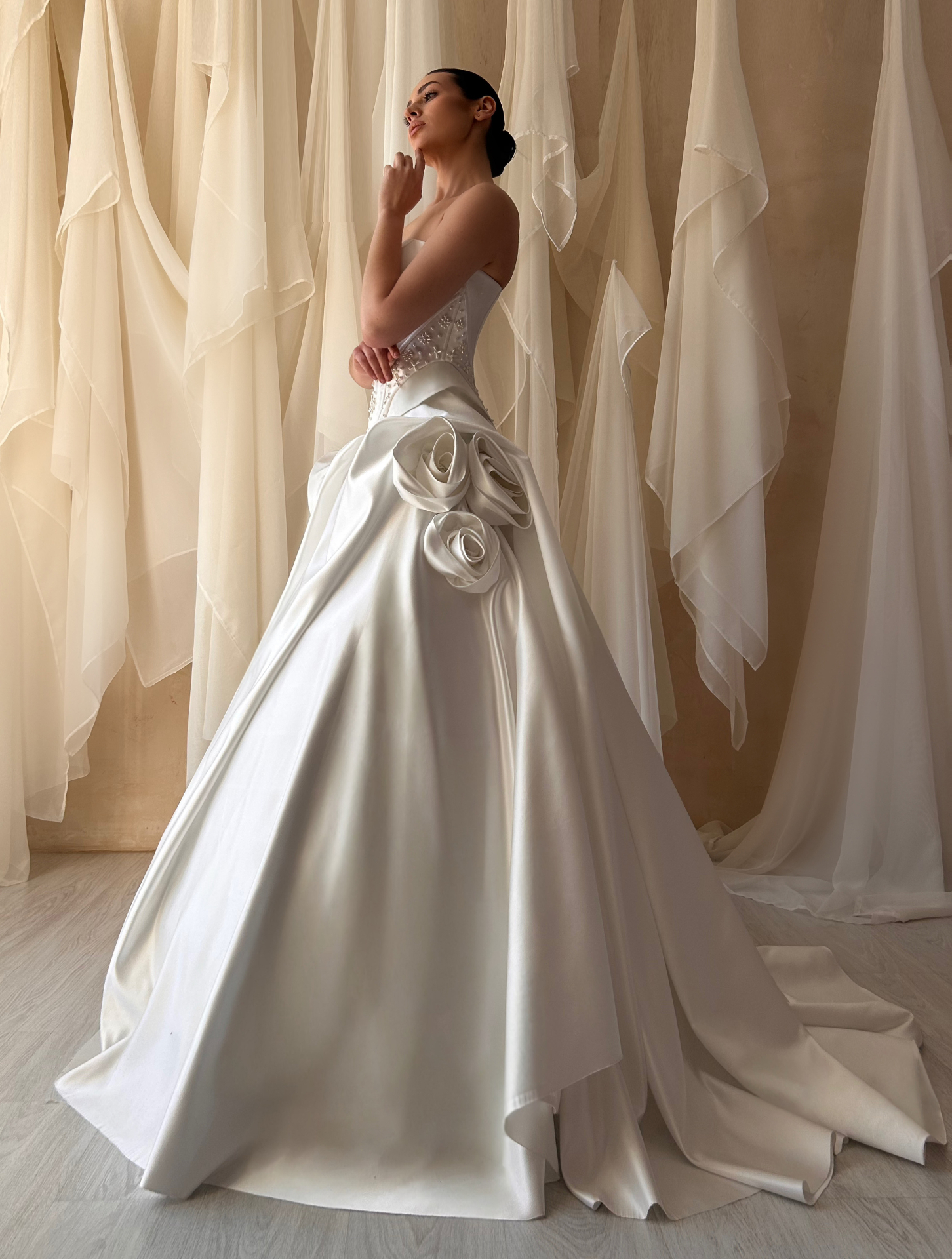 Ava — side view showcasing sculptural rosette detailing at the hips