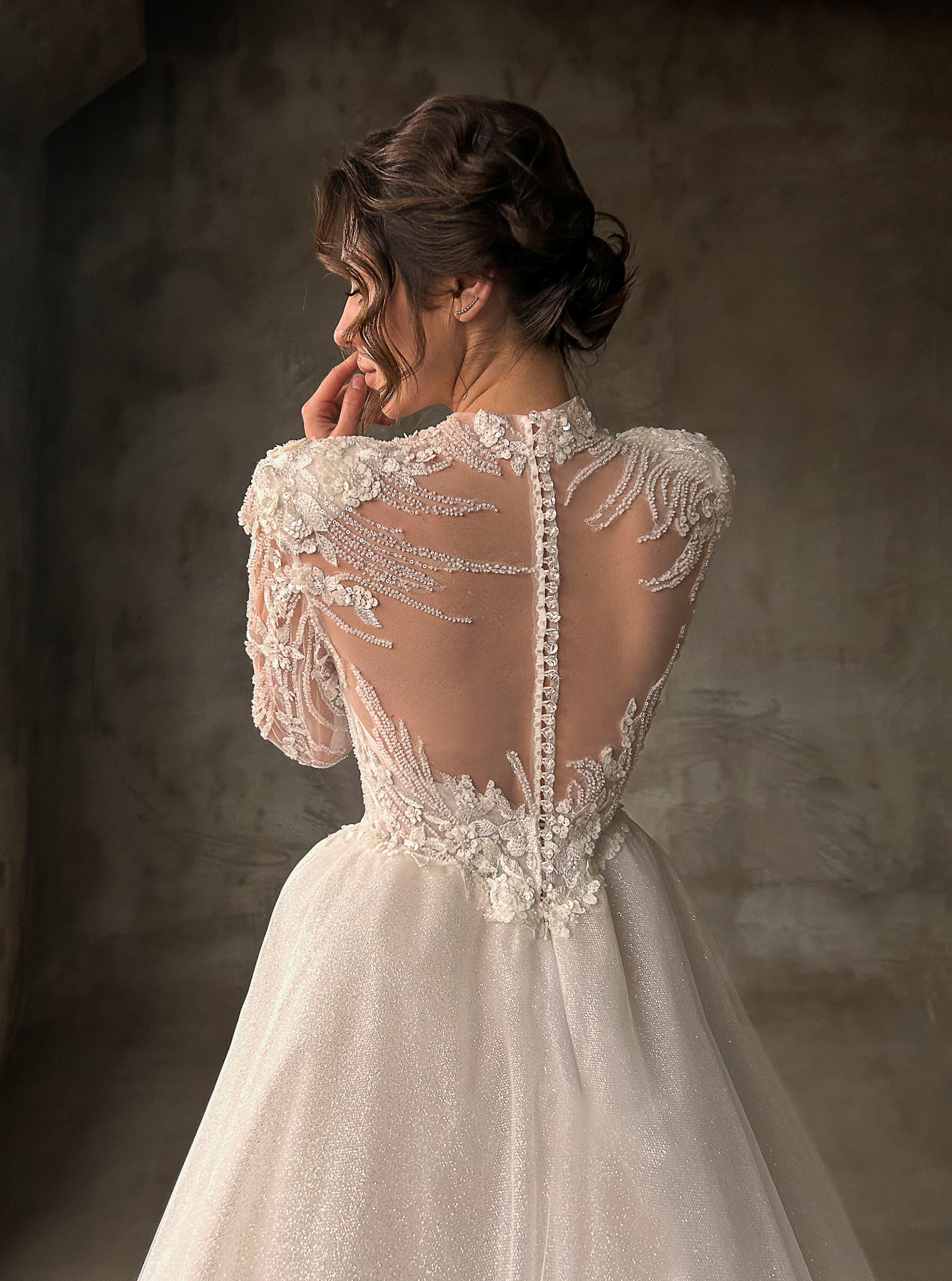 Ornella — close-up back detail of the illusion lace bodice with floral appliqués, covered buttons and structured overskirt